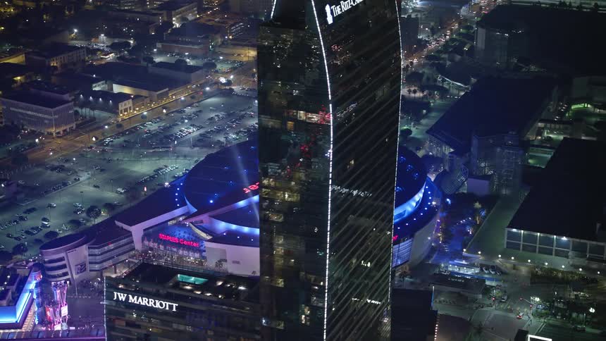 Spot lights shine into the night sky near the los angeles staples center sports arena