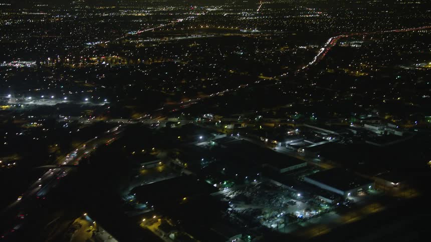 Aerial panorama of a highway with vehicle traffic in a metropolis at night