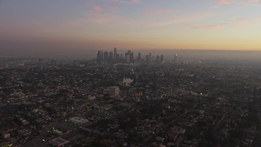 Panorama of a metropolis with skyscrapers and urban neighborhoods in a reddish sky