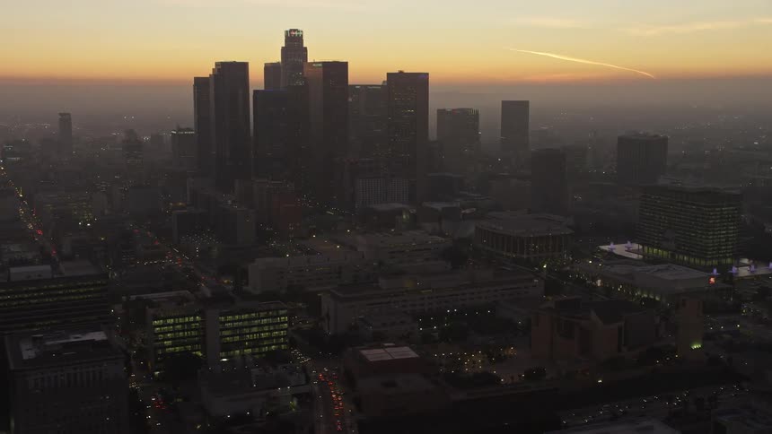Panorama of a metropolis with skylights and orange sky in the late afternoon