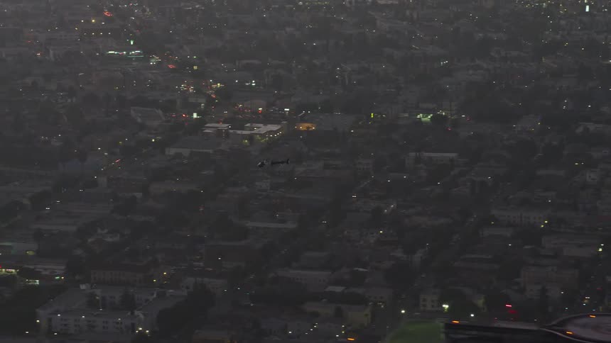 Traffic runs through the streets of the city at night