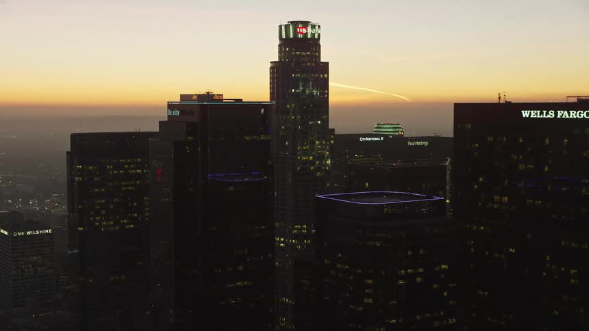 Panorama of modern skyscrapers in a metropolis with the reddish sky of dawn