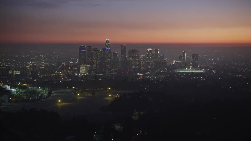 Aerial view los angeles at sunset behind a hill