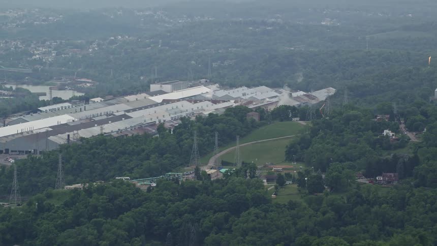 Aerial view of a factory and warehouse complex in a rural area
