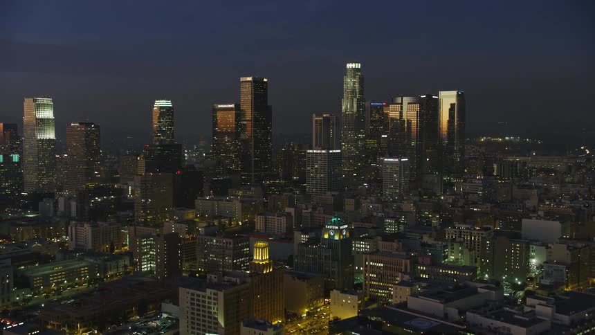 Aerial panorama of a metropolis with a modern skyscraper at night