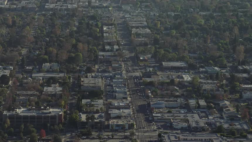 Cars drive down a street in a city
