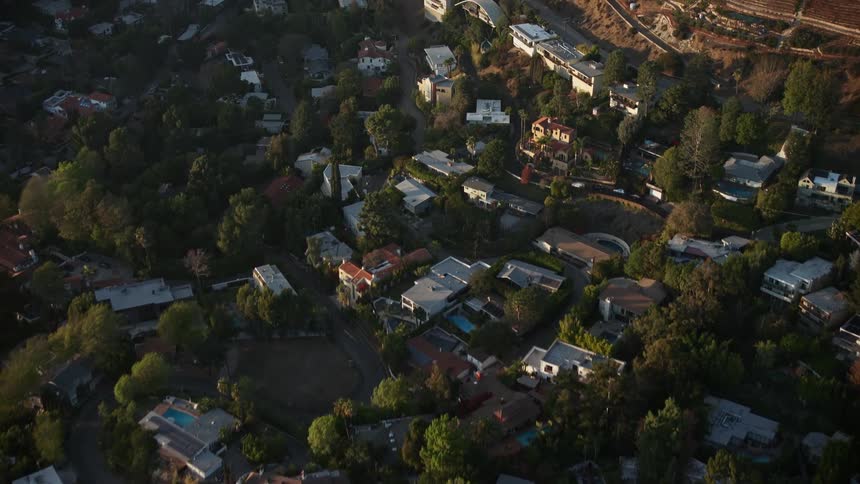 Aerial panorama of the city of urbana in the middle of a hill with vast vegetation one morning