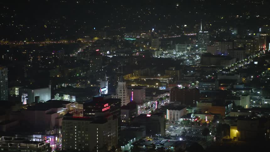 Aerial panorama of a metropolis with urban and commercial areas illuminated at night