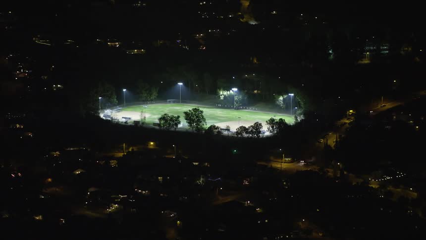 Aerial night view of a brightly lit sports field