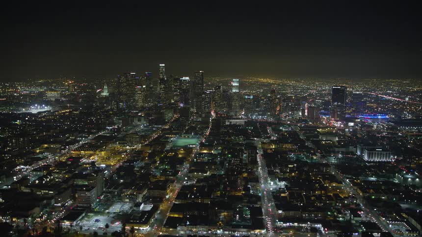 Aerial panorama of a metropolitan city with skyscrapers at night all lit up