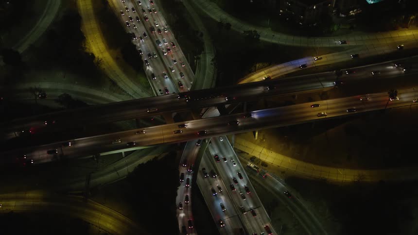 Traffic is running on the freeway at night