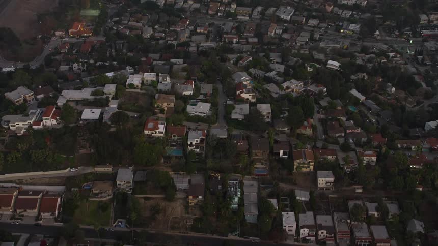 Aerial panorama of a residential city located on hills and with vegetation