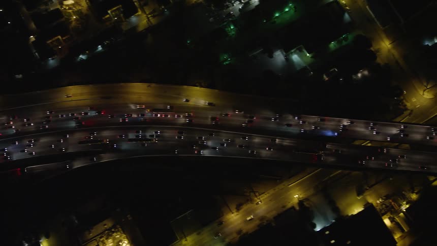 Aerial panorama of a highway with vehicle traffic at night