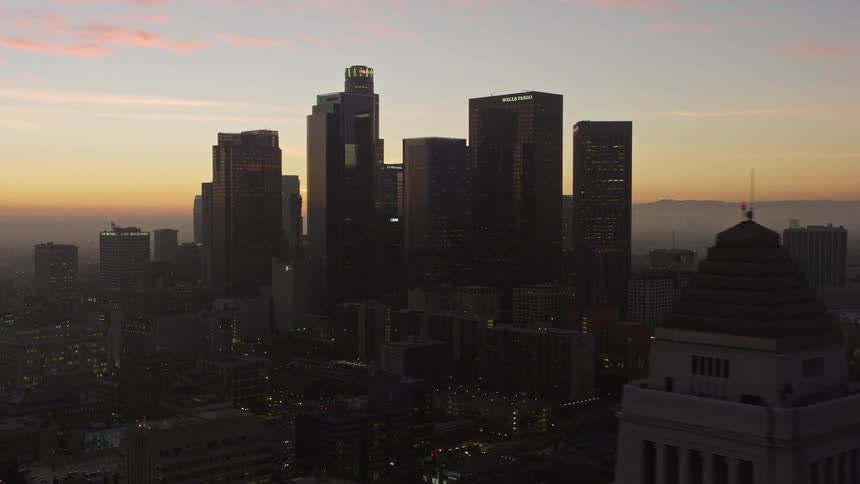 Aerial panorama of skyscrapers in the middle of a metropolis on a morning with an orange sky