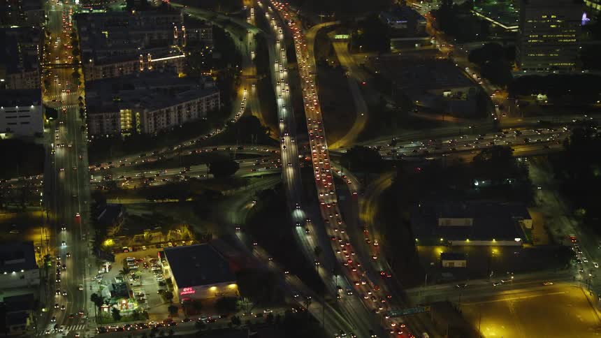 A highway with many cars and heavy traffic at night