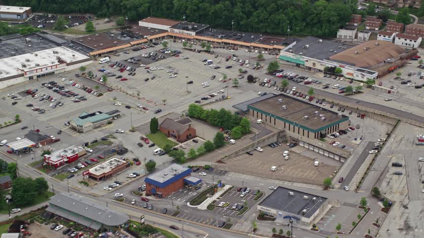 Aerial panorama of a parking lot and a half of stores in a city