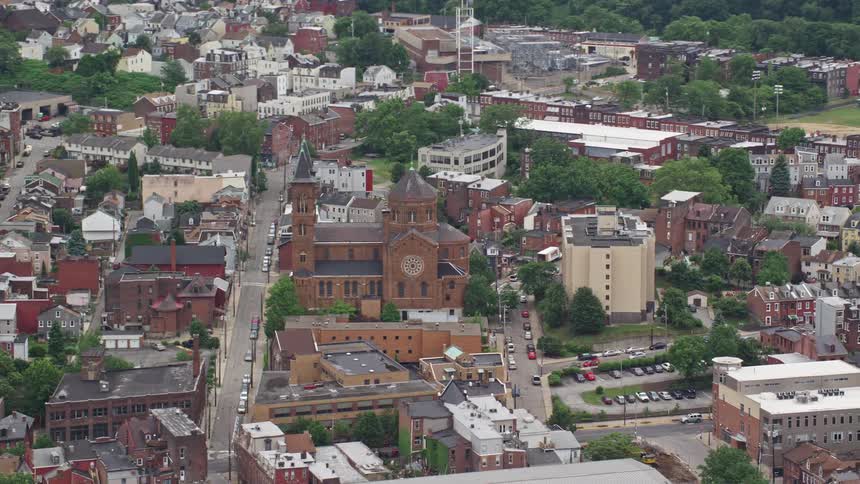 Aerial view of a town with densely packed buildings and a prominent church