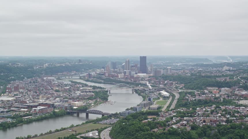 Aerial panorama of a residential neighborhood and in the background the cells in a metropolis on the edge of a river channel on a cloudy day