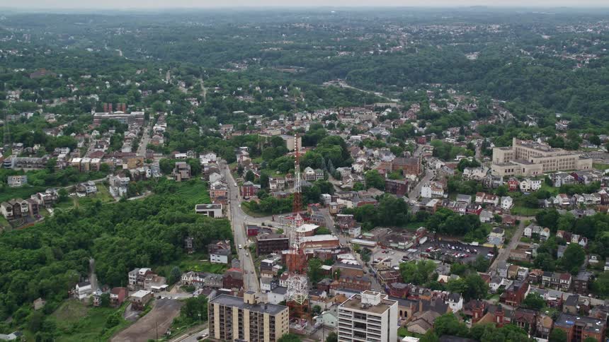 A suburb is up the hill from some warehouses