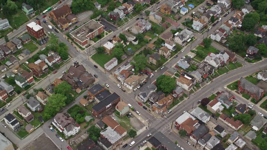 Aerial panorama of a residential neighborhood with scattered trees