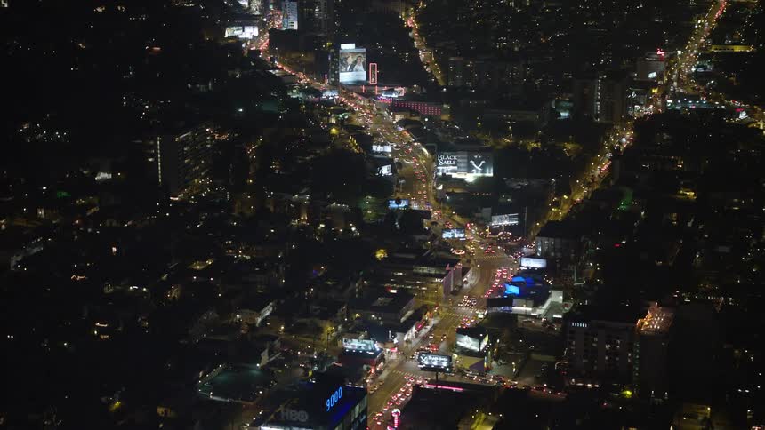Aerial panorama of a metropolis with highways with vehicle traffic at night