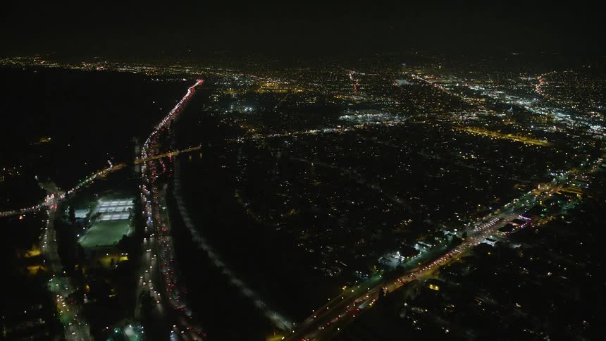 An aerial view of a road with lots of cars at night