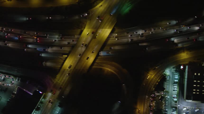 Nighttime aerial view of a highway with heavy traffic through the city