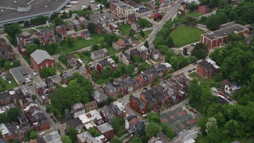 Homes cover the suburbs on a sunny day