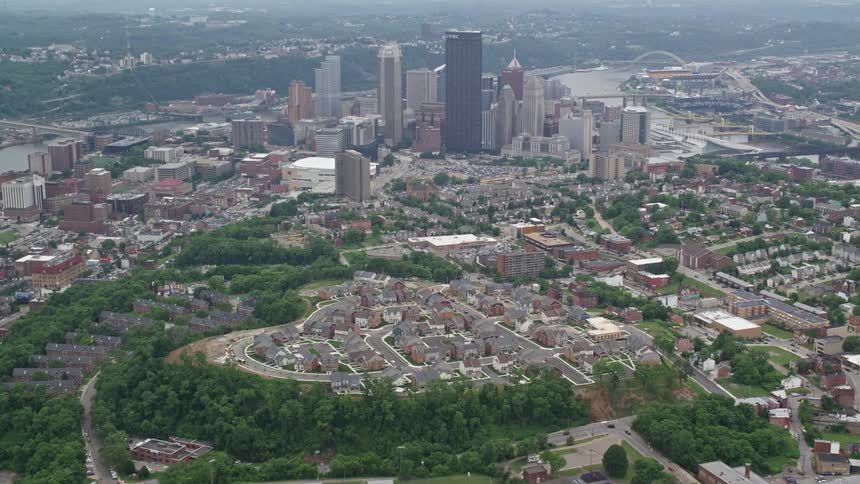 Aerial panorama of a city with urban neighborhoods recreational areas and skyscrapers on the banks of river canals