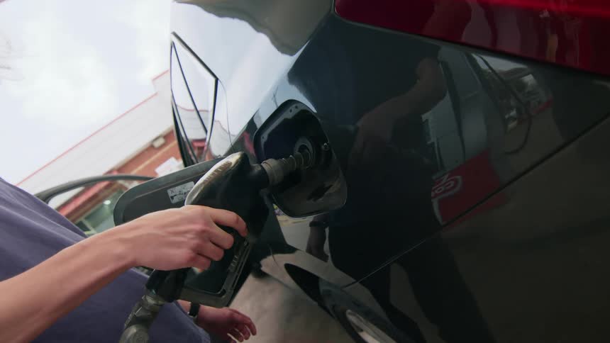 Person filling up their vehicle at a gas station