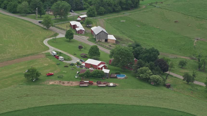 Aerial panorama of a hilly farm with a centralized highway