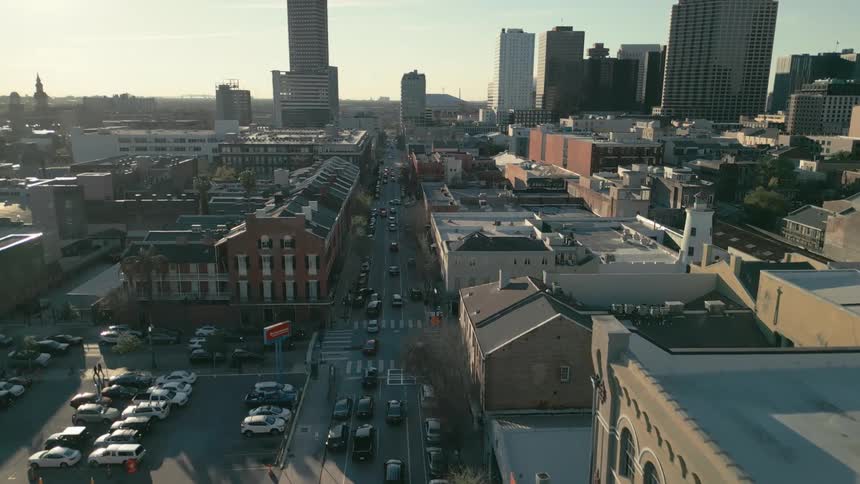 Aerial panorama of streets with vehicle traffic residential buildings and commercial skyscrapers on a morning