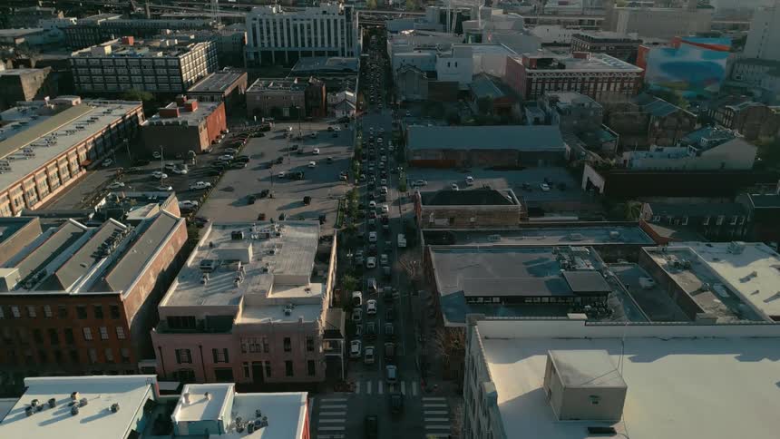 Aerial panorama of a city with streets with vehicle traffic in residential and commercial buildings