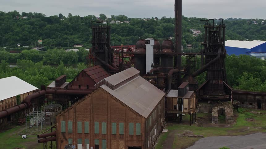 Factory with warehouses in a natural setting by a lake