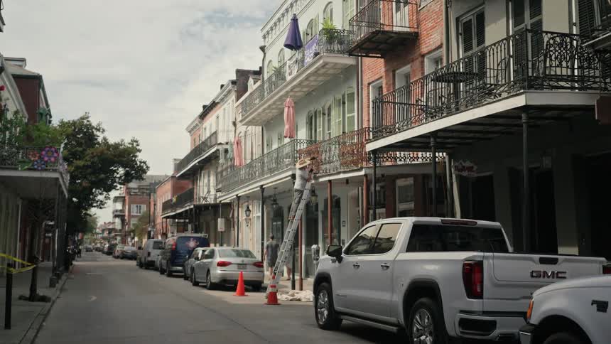 Street of a residential and commercial city with parked vehicles