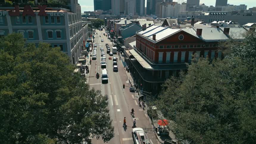 People crossing a new orleans street near the jax beer building
