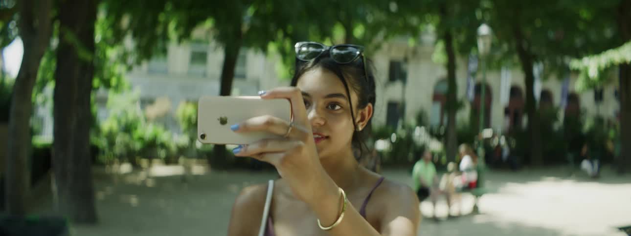 A young woman traveling in Paris takes a selfie