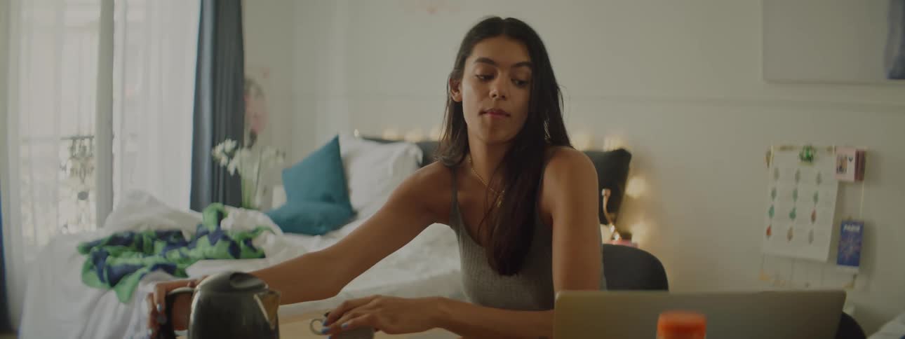 Young woman eating breakfast on a hotel bedroom