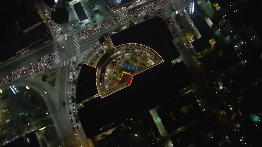 Aerial panorama of hotel buildings and vehicle traffic through the city at night