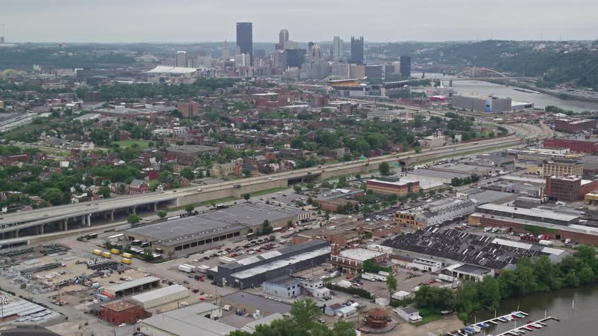 Panorama of a metropolitan city with residential neighborhoods shops and skyscrapers on the edge of a lake canal on a dubbed day