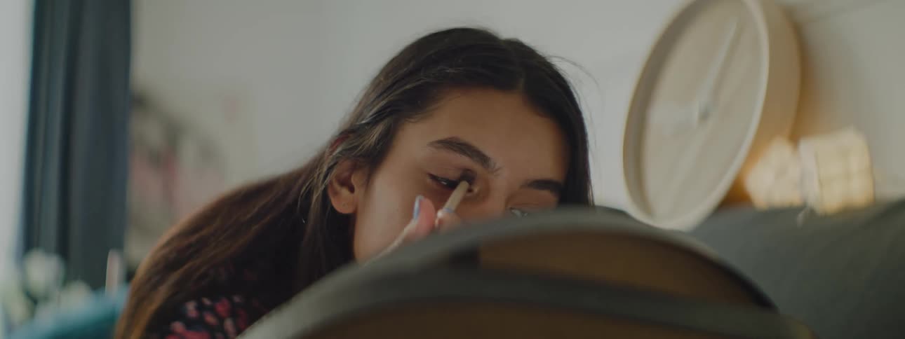 A woman is putting on makeup