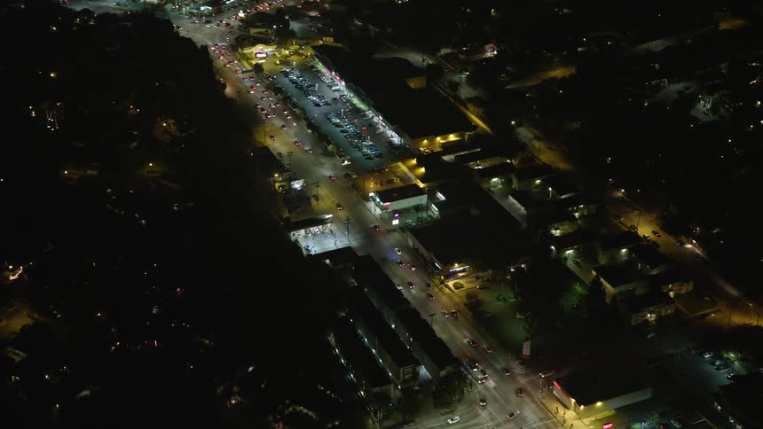 Cars travel busy roads in a busy city at night