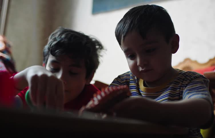 Two children play with toys together