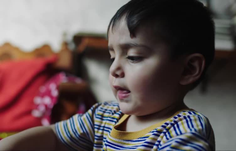 A toddler very focused while playing