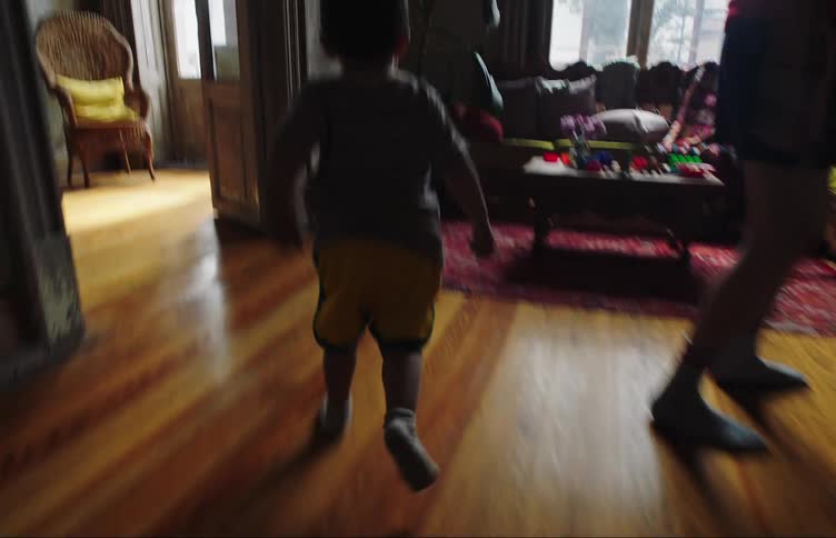 A child runs into the living room