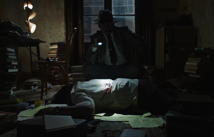 Silhouette of a detective inside a room at night with low lighting holding a flashlight and analyzing the body of a dead man with blood on his white shirt