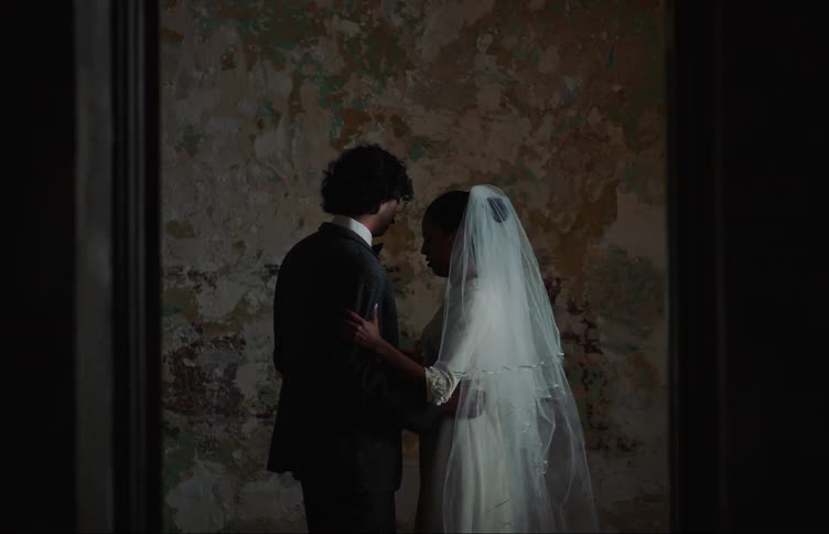 A just married couple dance indoors