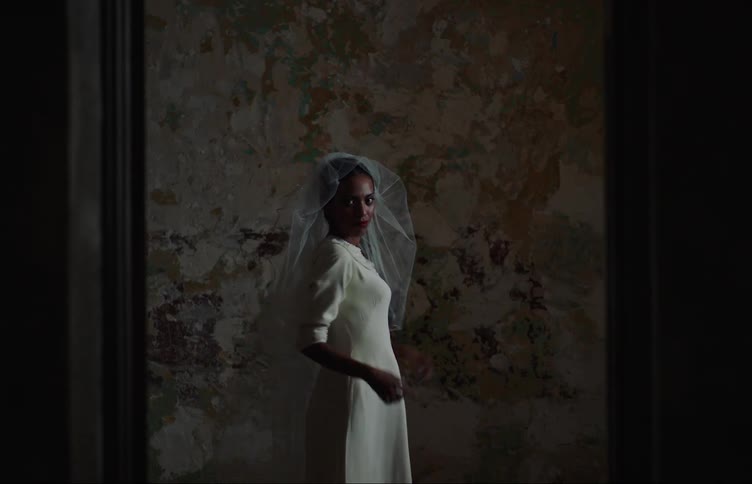 A woman is trying on a wedding dress