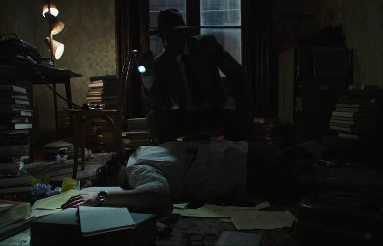 Two detectives with flashlights are looking at a body that is lying down and has a bloody wound