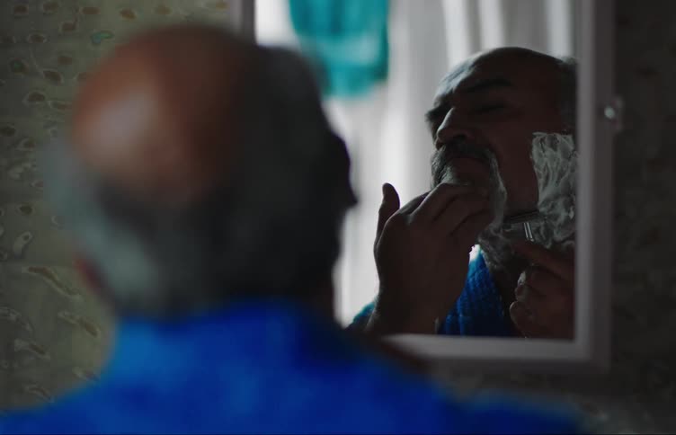 A man that is shaving runs out of the bathroom when an earthquake starts